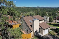 an aerial view of a home in the mountains